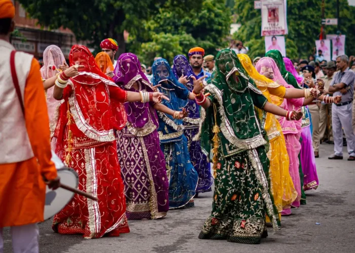 Vibrant traditional dancers in colorful attire participating in a street parade.