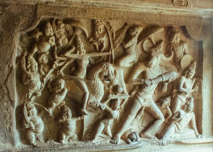 Detailed stone relief depicting mythological scene in Indian architecture.